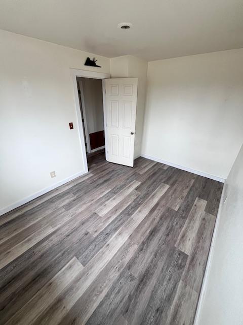 116 Happy Holw, Eureka, MT 59917 - unfurnished room featuring dark wood finished floors and baseboards