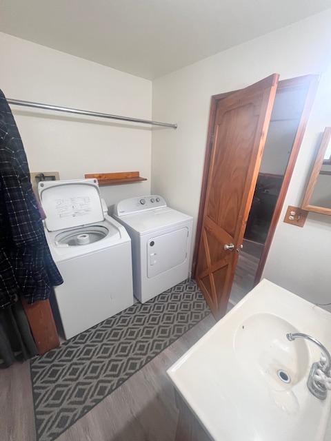 116 Happy Holw, Eureka, MT 59917 - laundry area with washer and clothes dryer and wood finished floors