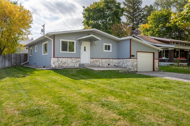 view of front of property featuring a chimney, an attached garage, fence, driveway, and a front lawn