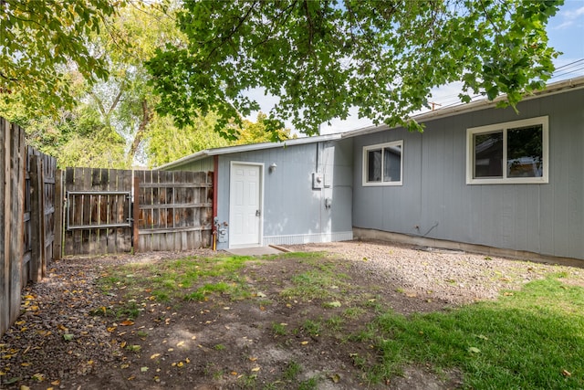 rear view of house featuring fence