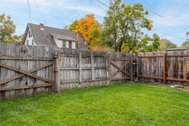 view of yard featuring fence and a gate