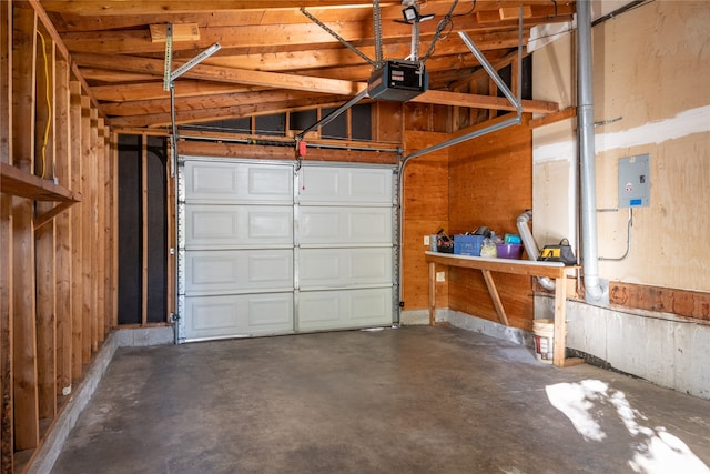 garage featuring a garage door opener and wooden walls