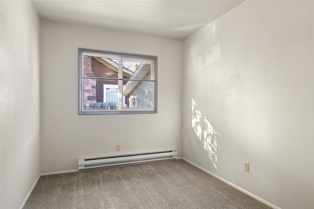 spare room featuring carpet floors, a baseboard radiator, and baseboards