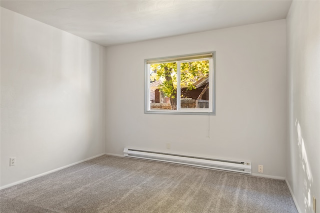 empty room featuring carpet floors, baseboards, and baseboard heating