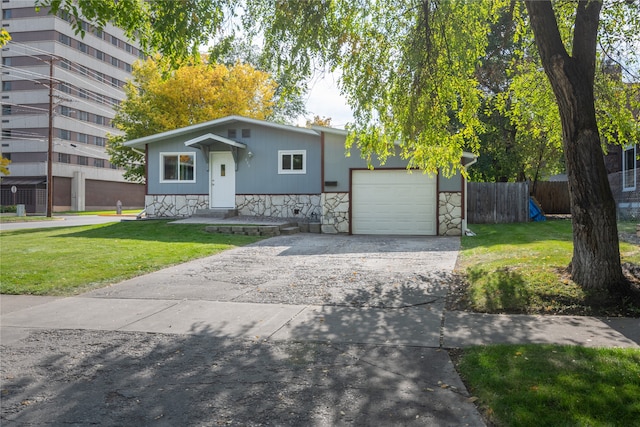 view of front of home featuring concrete driveway, stone siding, an attached garage, fence, and a front lawn