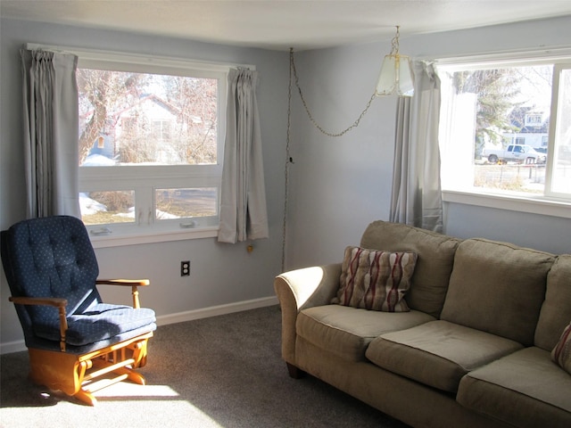 carpeted living area with baseboards