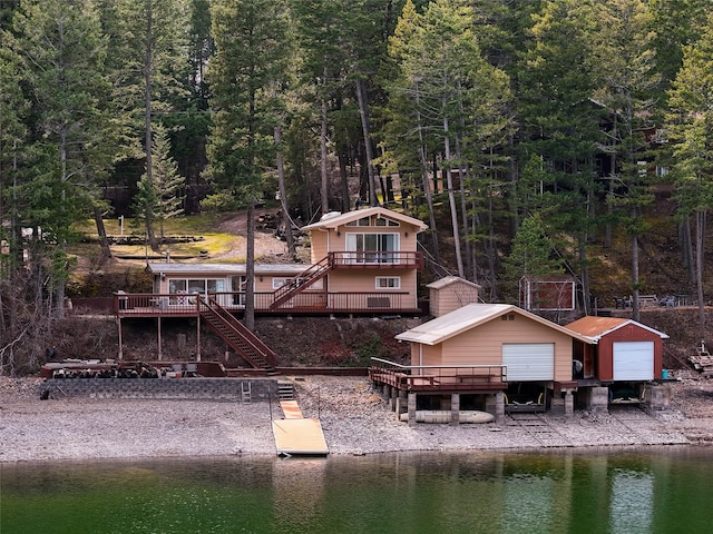 237 Lake Blaine Dr, Kalispell, MT 59901 - dock area with stairs, a forest view, and a deck with water view
