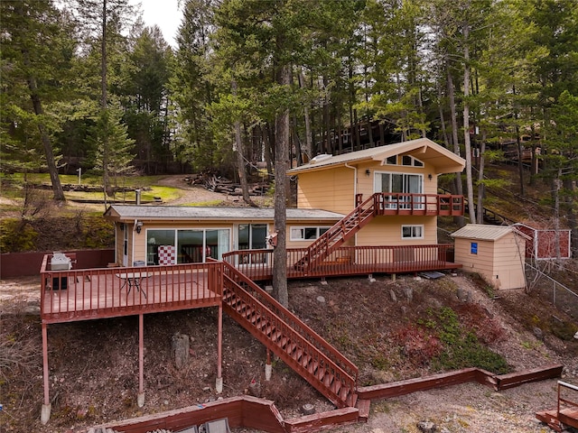237 Lake Blaine Dr, Kalispell, MT 59901 - rear view of property with an outbuilding, a wooden deck, stairway, and a storage unit