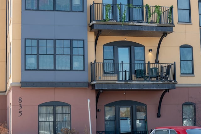 exterior space with a balcony and stucco siding