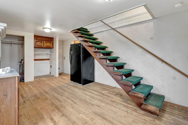 stairs featuring wood finished floors