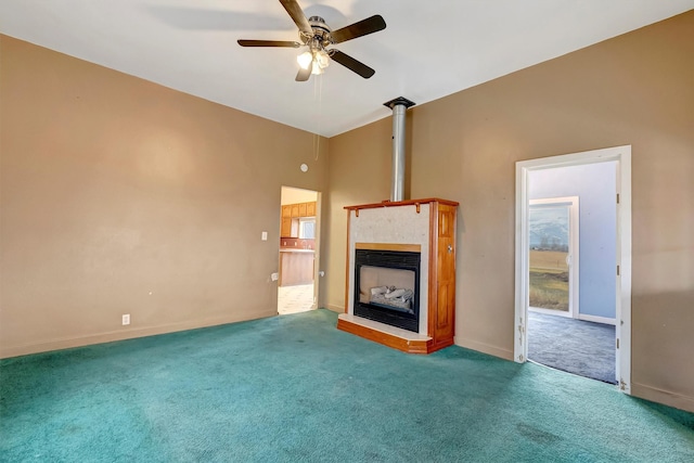 unfurnished living room featuring carpet floors, ceiling fan, a fireplace, and baseboards