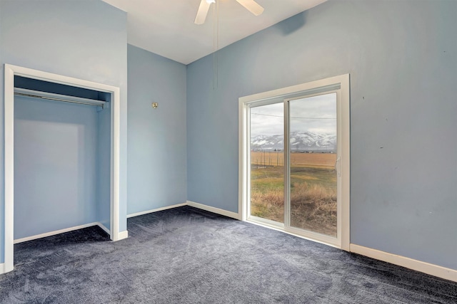 unfurnished bedroom featuring carpet flooring, a ceiling fan, and baseboards