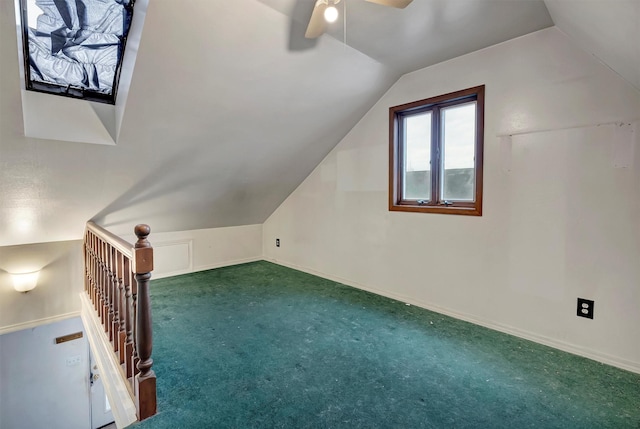 additional living space featuring carpet floors, baseboards, vaulted ceiling, and a ceiling fan