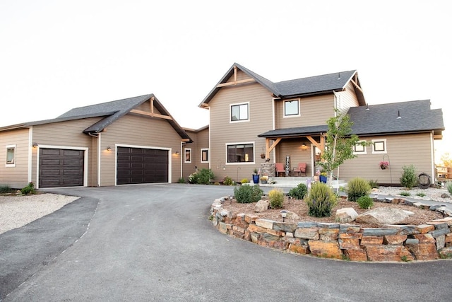 craftsman inspired home with an attached garage and driveway