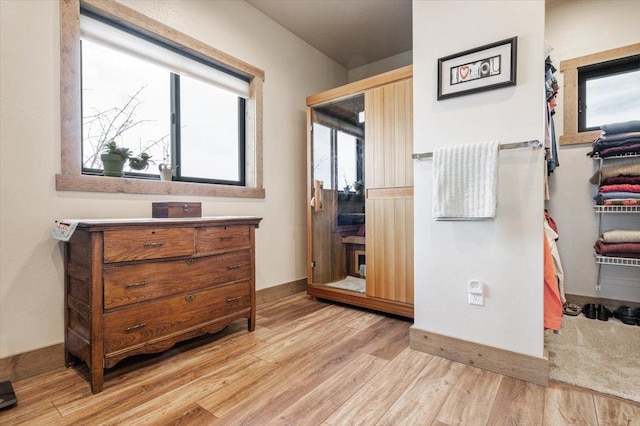 bathroom with baseboards, wood finished floors, and vanity