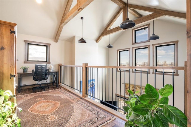 office space with plenty of natural light, high vaulted ceiling, wood finished floors, and beamed ceiling