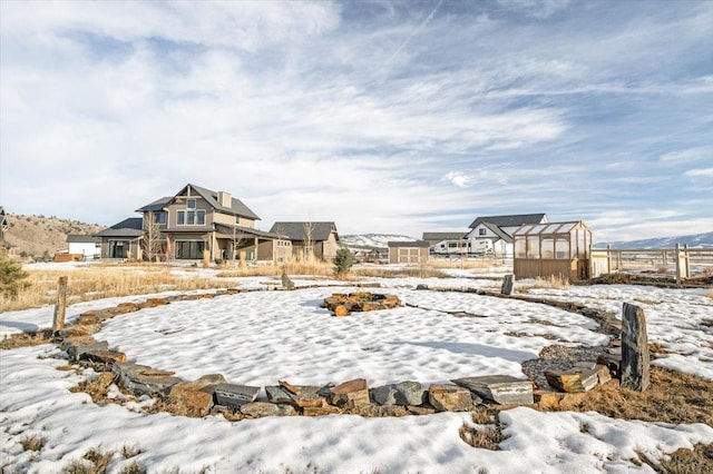 snowy yard featuring an outdoor structure and an exterior structure