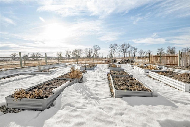 view of patio featuring fence and a vegetable garden