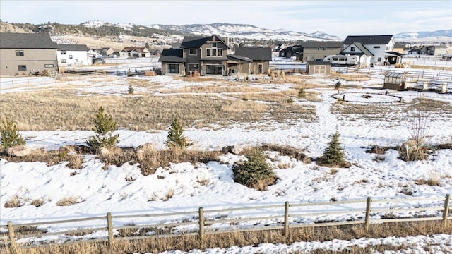 view of yard with a residential view, fence, and a mountain view