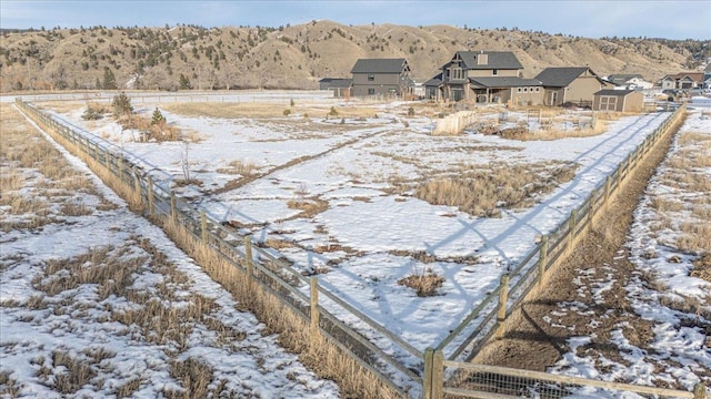 yard layered in snow with fence