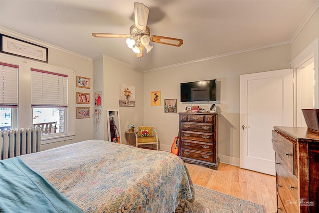 bedroom with ornamental molding, light wood-type flooring, ceiling fan, and radiator heating unit