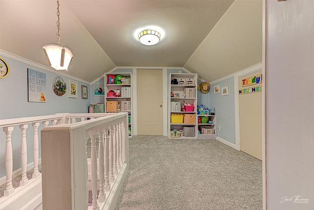 bedroom featuring lofted ceiling, a crib, carpet, and crown molding