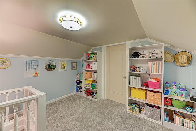 carpeted bedroom featuring lofted ceiling and a crib