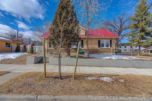 view of front of home with fence and brick siding