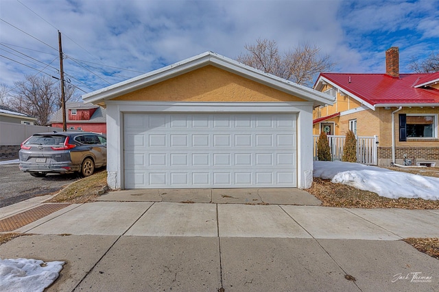 detached garage featuring fence