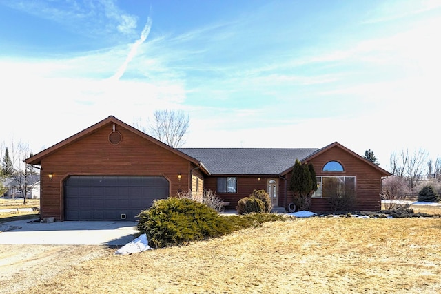 view of front facade with concrete driveway and an attached garage