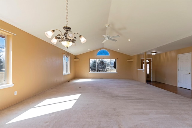 interior space featuring carpet, lofted ceiling, and ceiling fan with notable chandelier