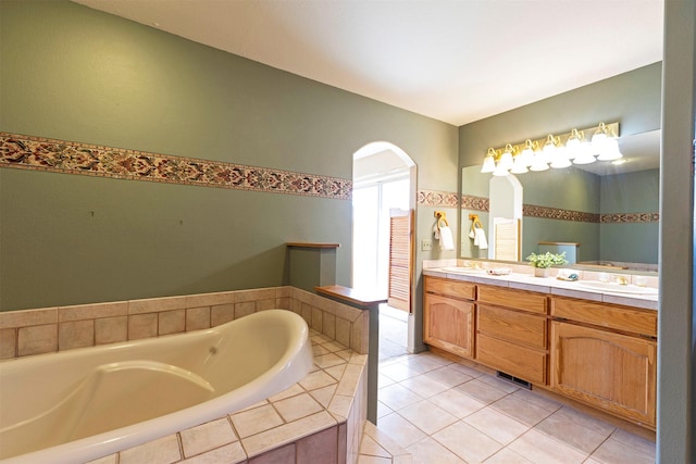 full bathroom with tile patterned floors, a garden tub, a sink, and double vanity