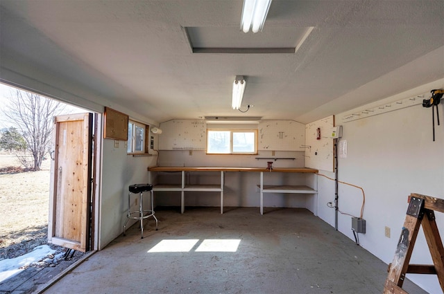 interior space with a textured ceiling and a workshop area