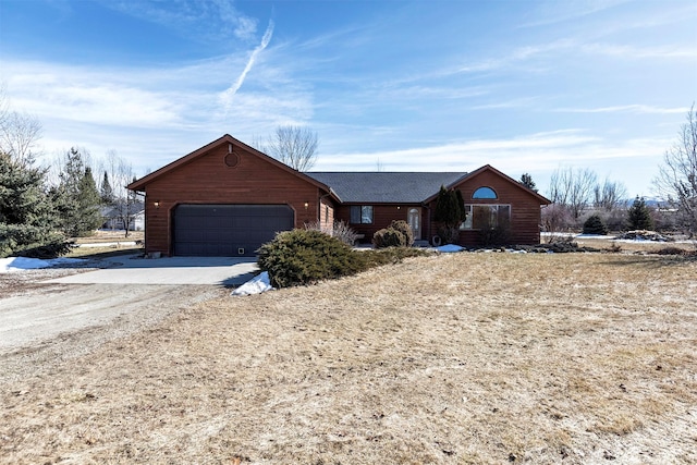 view of front of property with concrete driveway and an attached garage