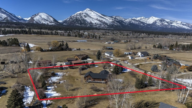 birds eye view of property featuring a mountain view and a rural view