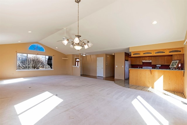 kitchen with light colored carpet, freestanding refrigerator, open floor plan, vaulted ceiling, and under cabinet range hood