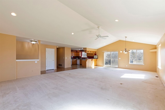 unfurnished living room featuring recessed lighting, visible vents, lofted ceiling, carpet floors, and ceiling fan with notable chandelier