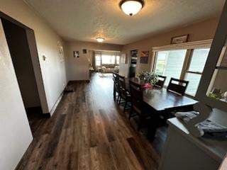 dining area featuring wood finished floors and baseboards