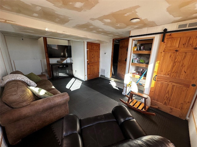 living room with a barn door and visible vents