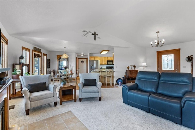 living room featuring vaulted ceiling, light tile patterned floors, plenty of natural light, and an inviting chandelier