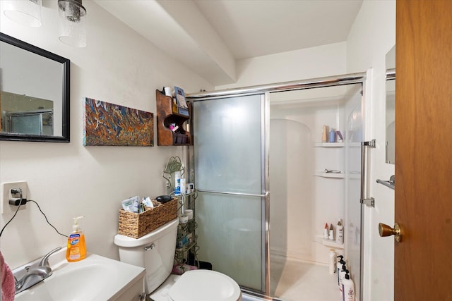 bathroom featuring a stall shower, toilet, and vanity