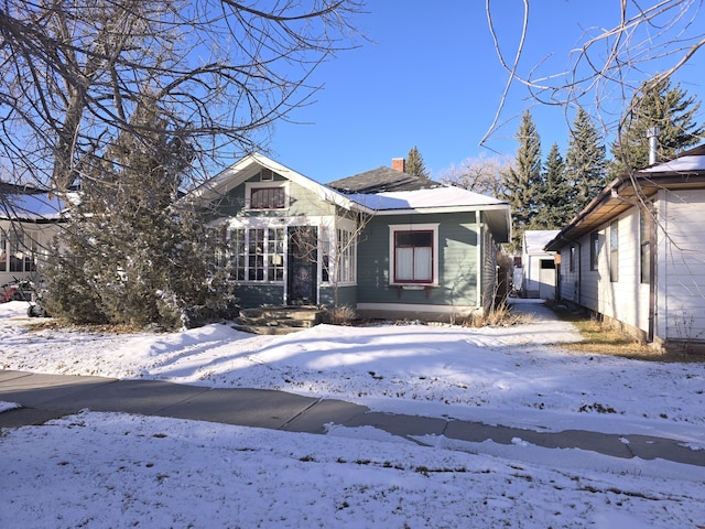 bungalow-style house featuring a chimney