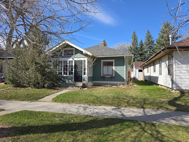 324 1st Ave NW, Choteau, MT 59422 - view of front of property featuring a front lawn and a chimney