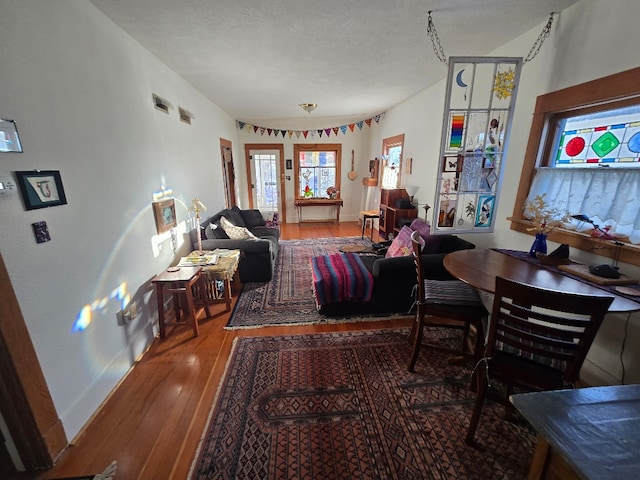 living area with hardwood / wood-style floors and baseboards