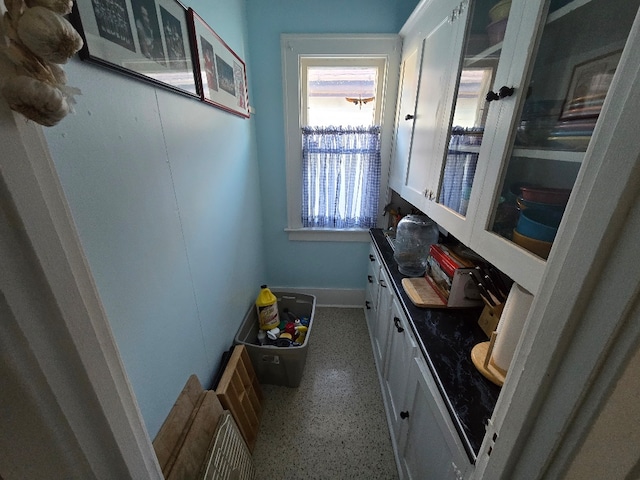 bathroom with speckled floor and vanity