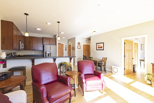 living room with baseboards and light wood-style floors