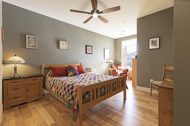 bedroom featuring light wood-type flooring, ceiling fan, and baseboards