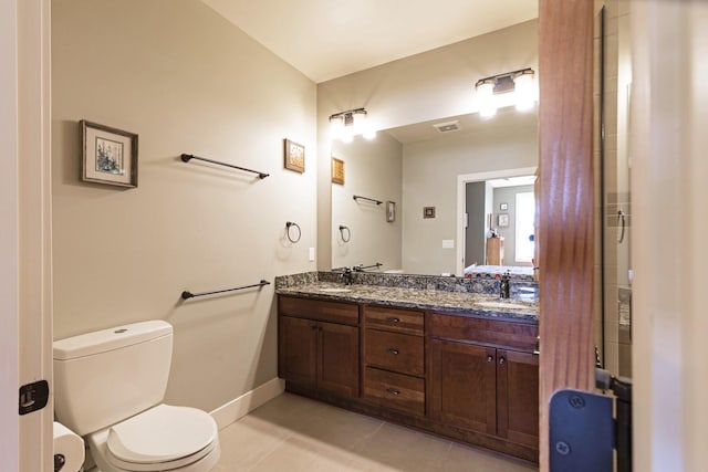 full bathroom featuring tile patterned flooring, a sink, toilet, and double vanity