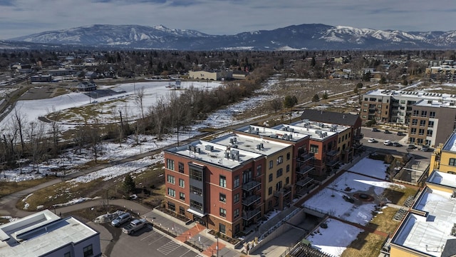 snowy aerial view with a mountain view