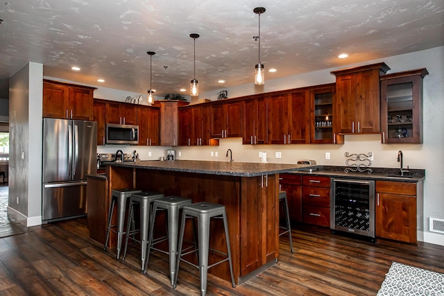 kitchen featuring beverage cooler, stainless steel appliances, dark wood-style flooring, and a sink